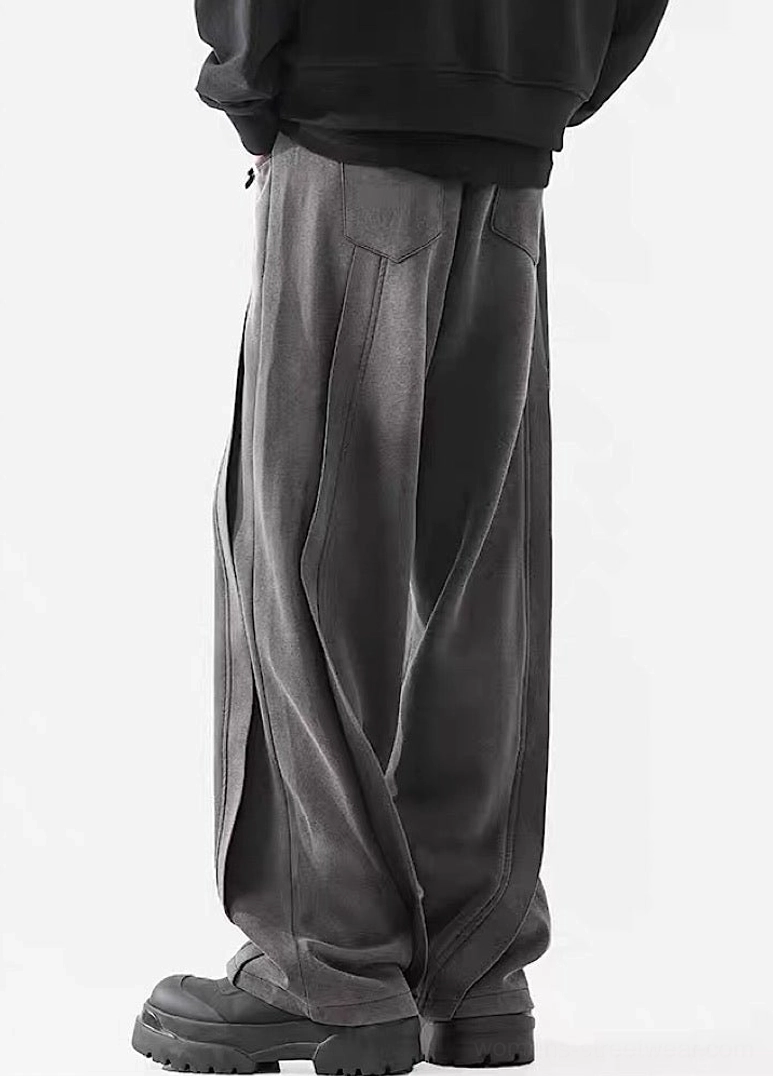 Rear side view of dark gray wide-leg streetwear pants with washed fabric, vertical seams, and practical relaxed styling