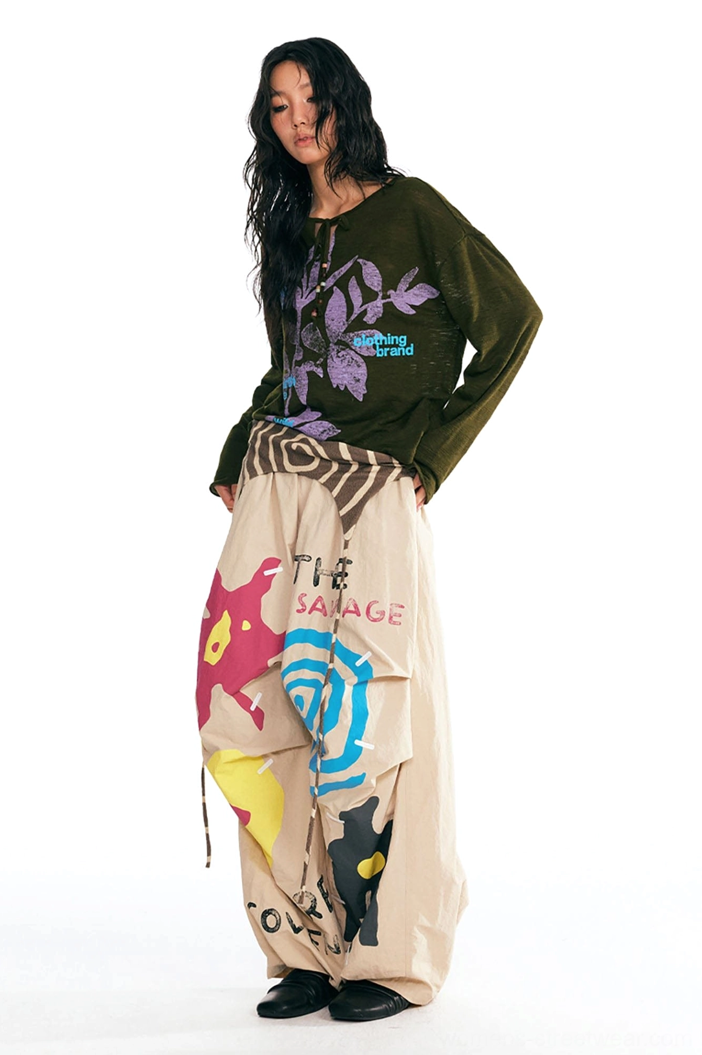 Dark green Acubi streetwear long-sleeve tee with purple plant print shown in a full-body front three-quarter view