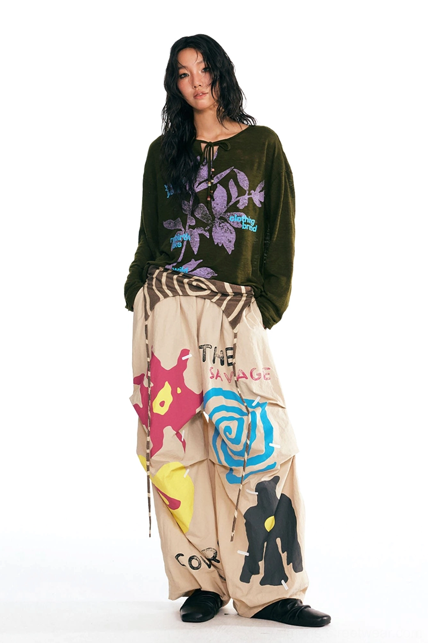 Dark green drawstring neck botanical graphic long-sleeve tee styled with abstract printed wide-leg trousers