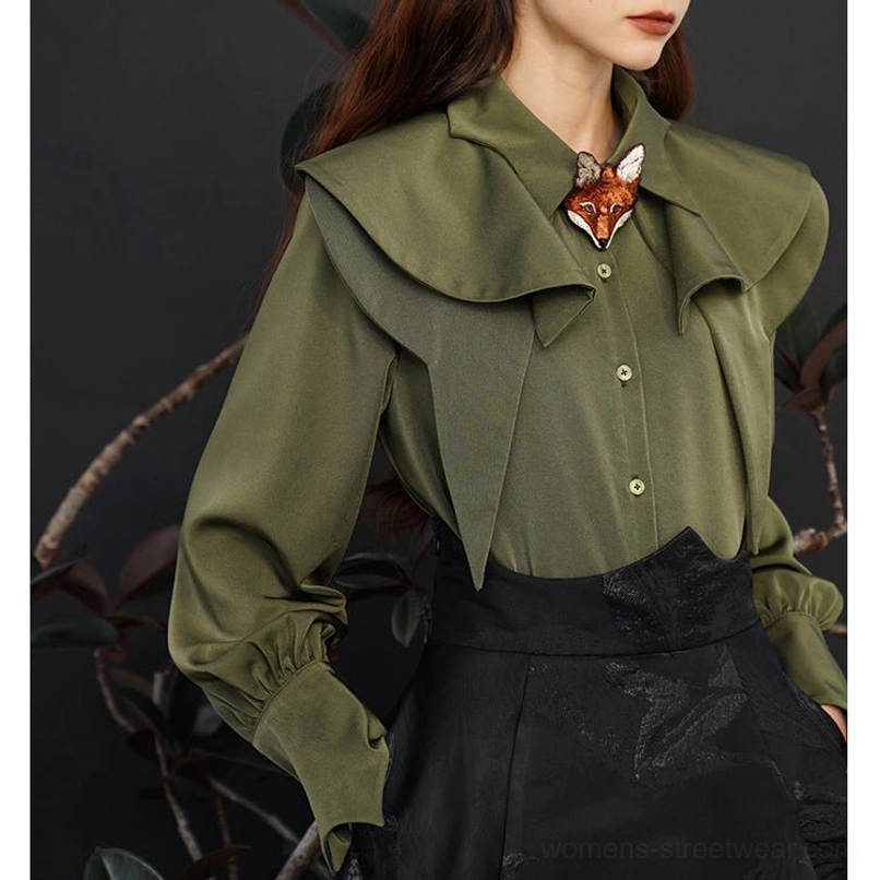 Three quarter view of dark green fox charm blouse with fitted waist shape, layered collar, and front buttons
