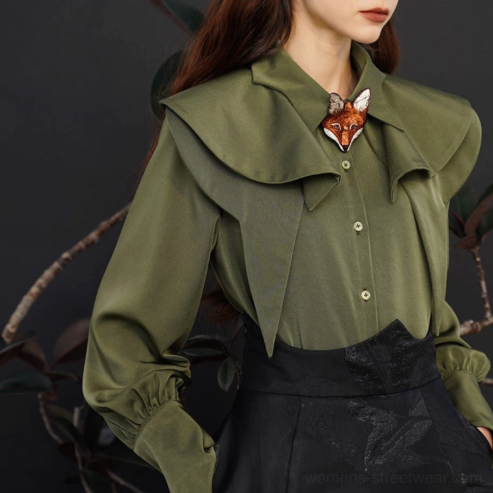Dark green streetwear blouse with pointed layered collar, fox charm detail, and button front styling