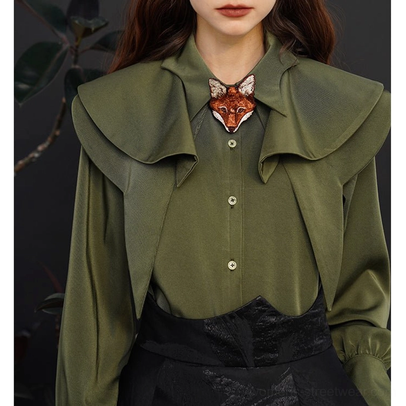 Dark green fox charm ruffle blouse with gathered lantern sleeves and layered collar styled with black skirt