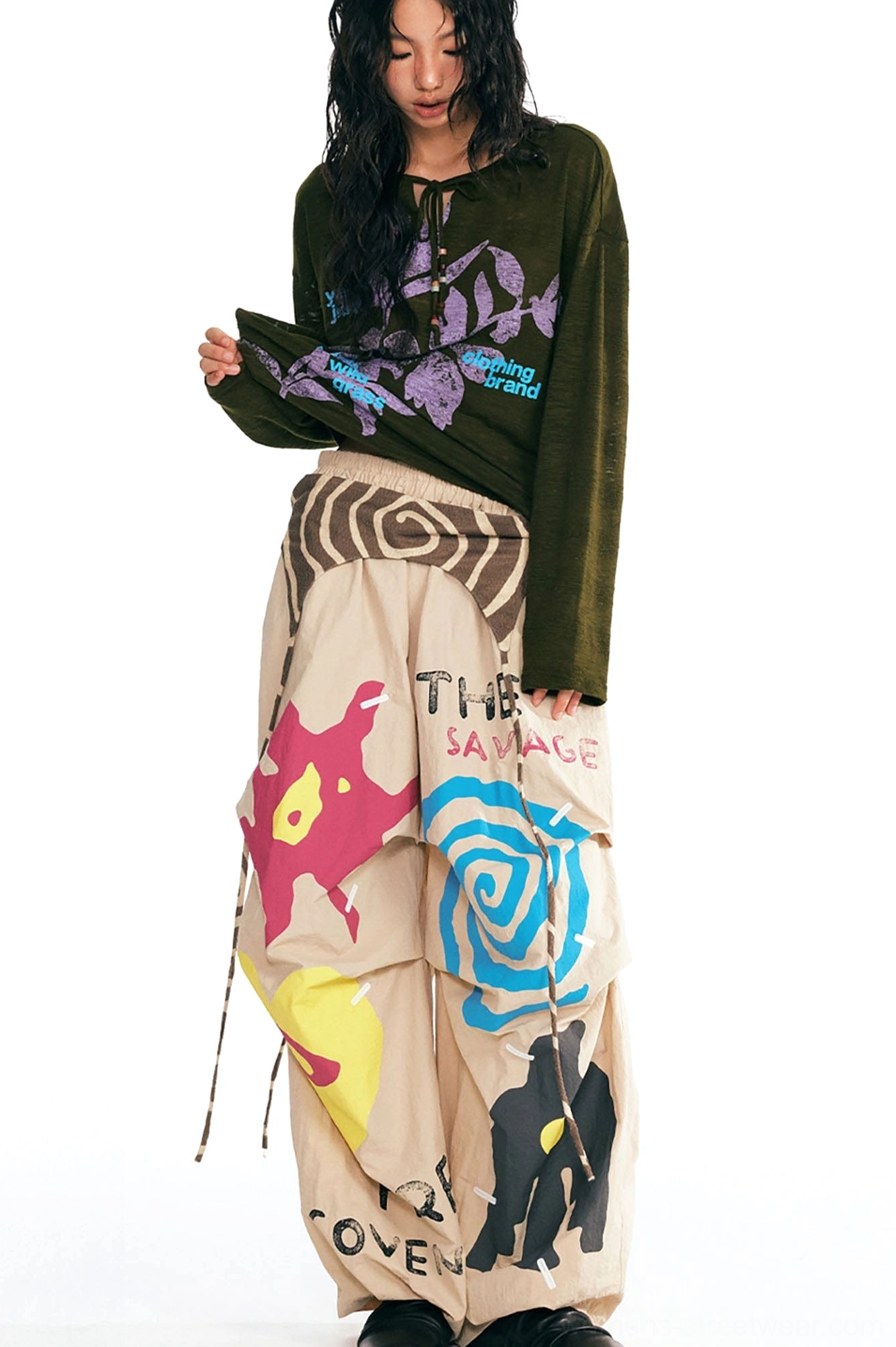 Dark olive green sesame leaf graphic long-sleeve tee paired with loose beige wide-leg pants