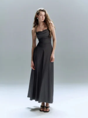 Dark grey floor length formal dress with ruched bodice flowing A line skirt and strapless neckline shown in a full body front studio view