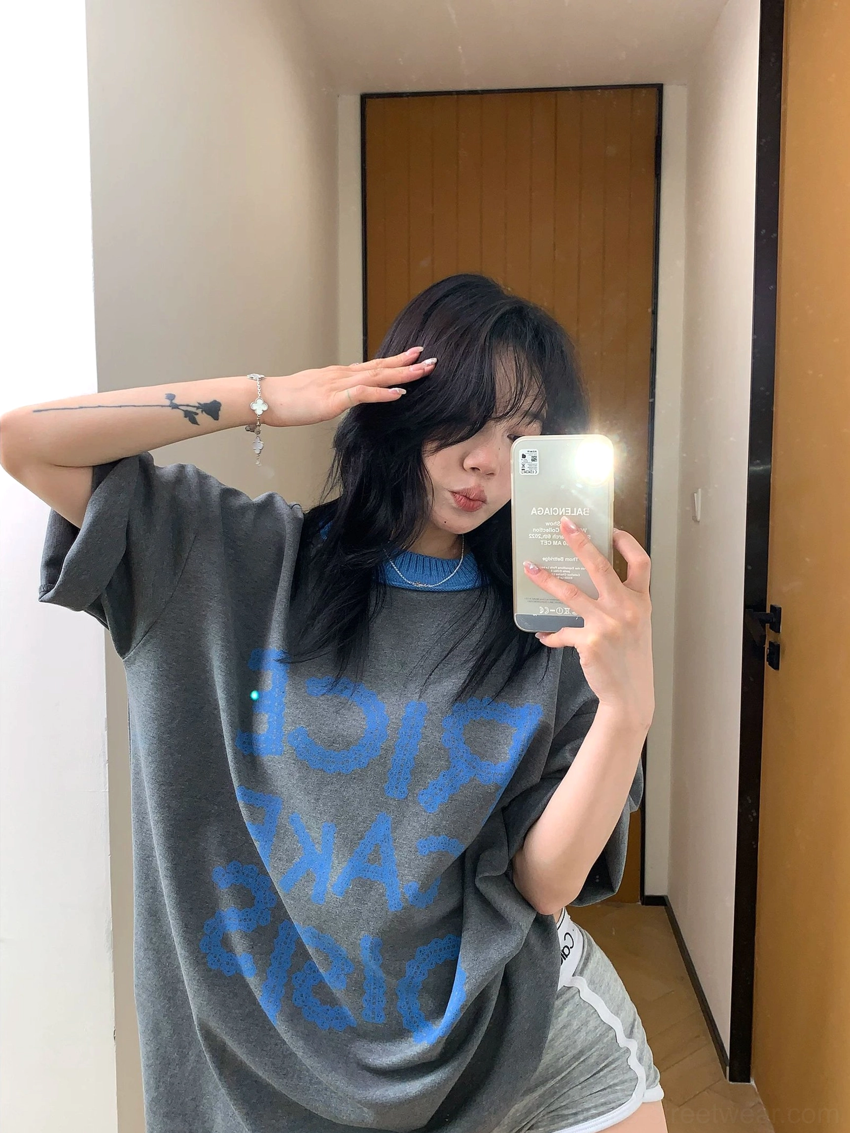 Dark heather grey oversized cotton-blend T-shirt with reversed blue front graphic and rolled short sleeves styled with light grey biker shorts