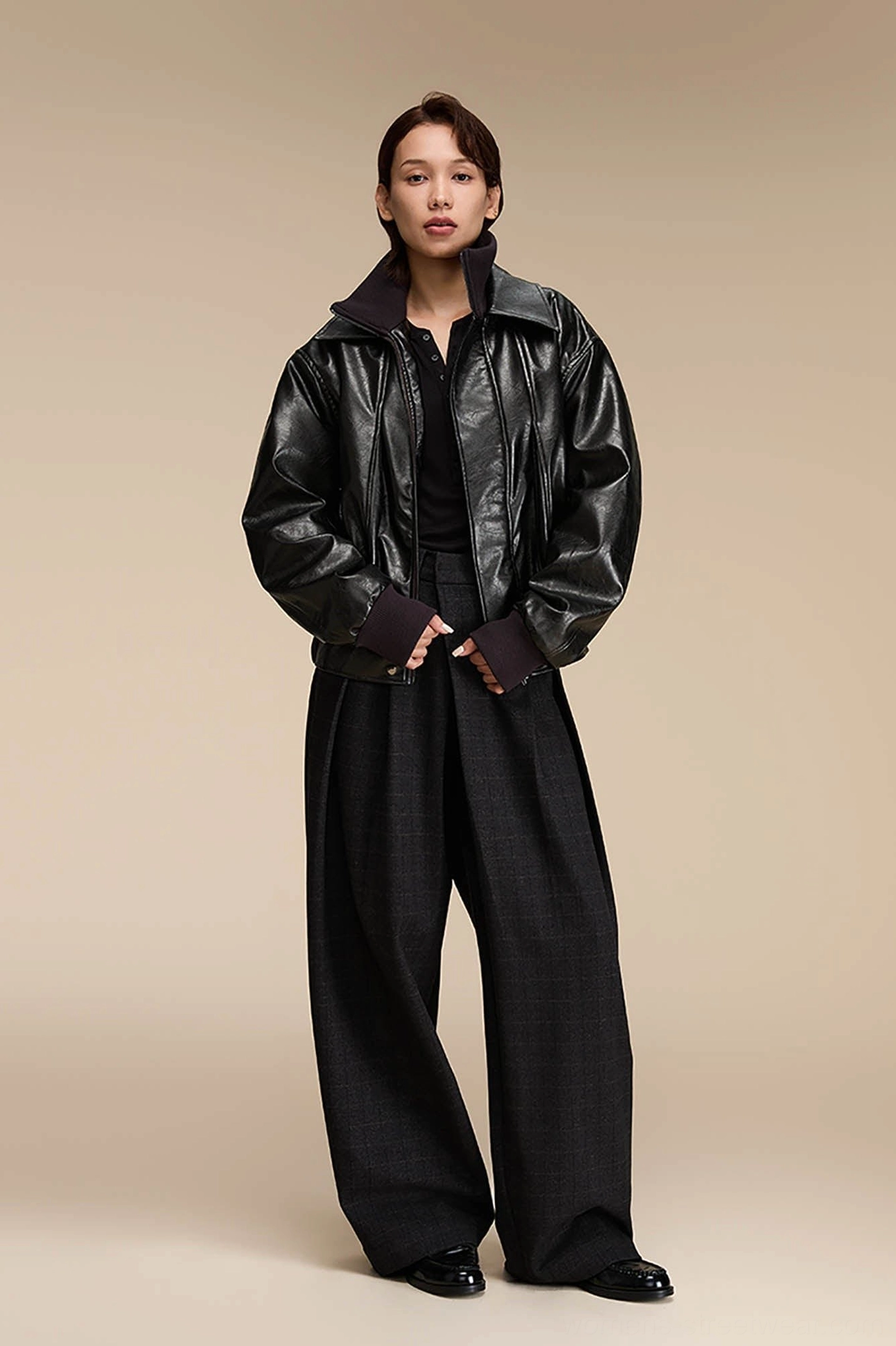 Dark grey plaid wide-leg office trousers styled with a black top and leather jacket for a modern Korean streetwear outfit