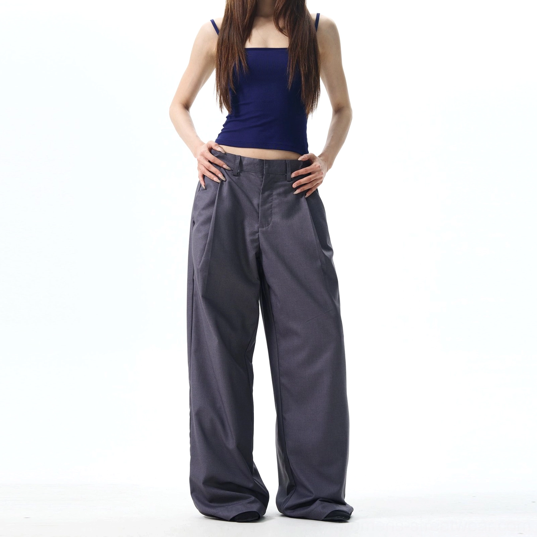 Dark grey pleated wide-leg streetwear pants with high waist, elegant suiting structure, and relaxed contemporary silhouette