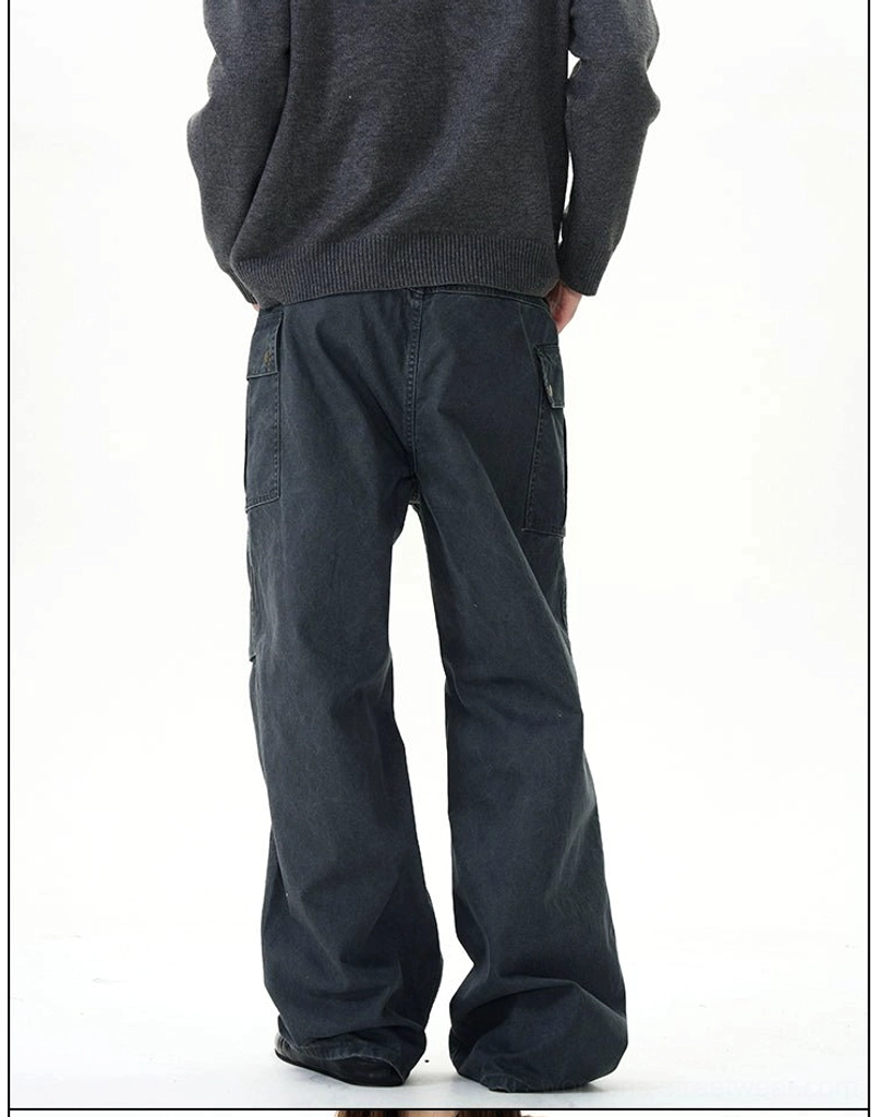 Back view of dark grey vintage cargo pants showing paneled leg seams, loose baggy fit, and rear waistband details