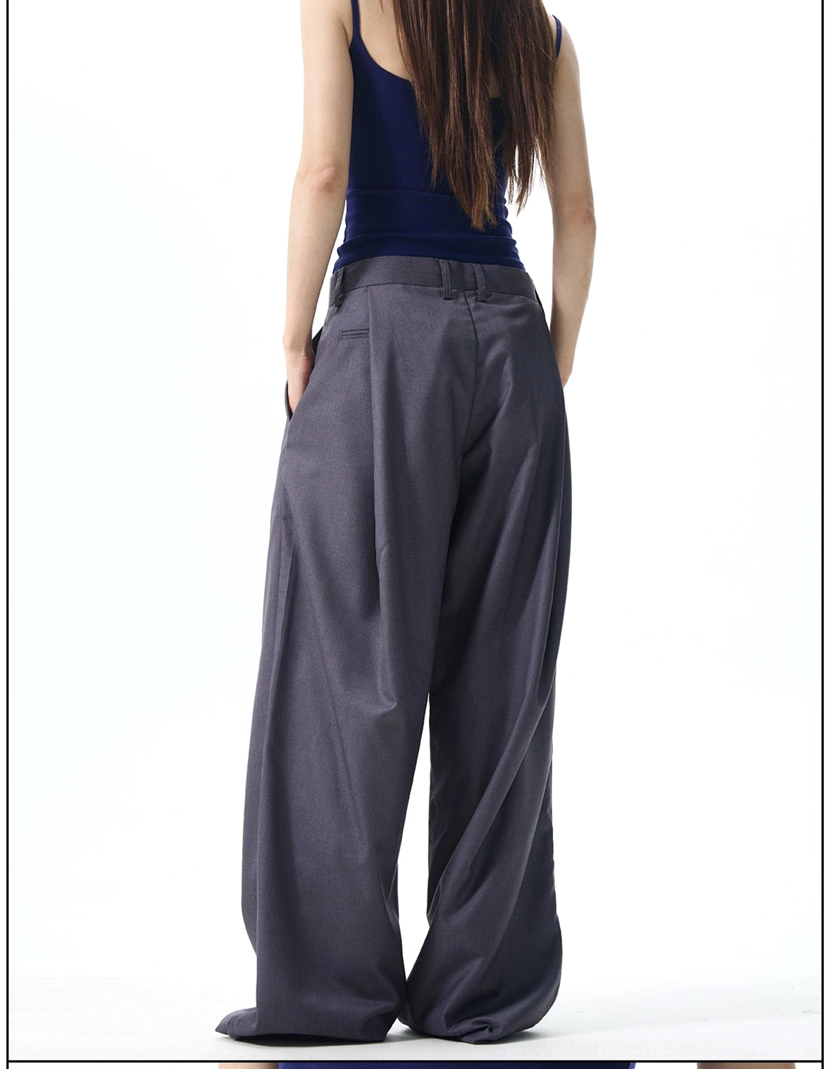 Back view of dark grey wide-leg dress pants showing the smooth rear waistband and relaxed floor-length trouser silhouette