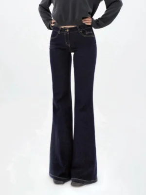Front view of dark indigo contrast stitch flared jeans with a mid-rise waist, slim leg fit, classic pockets, and full-length Y2K streetwear silhouette