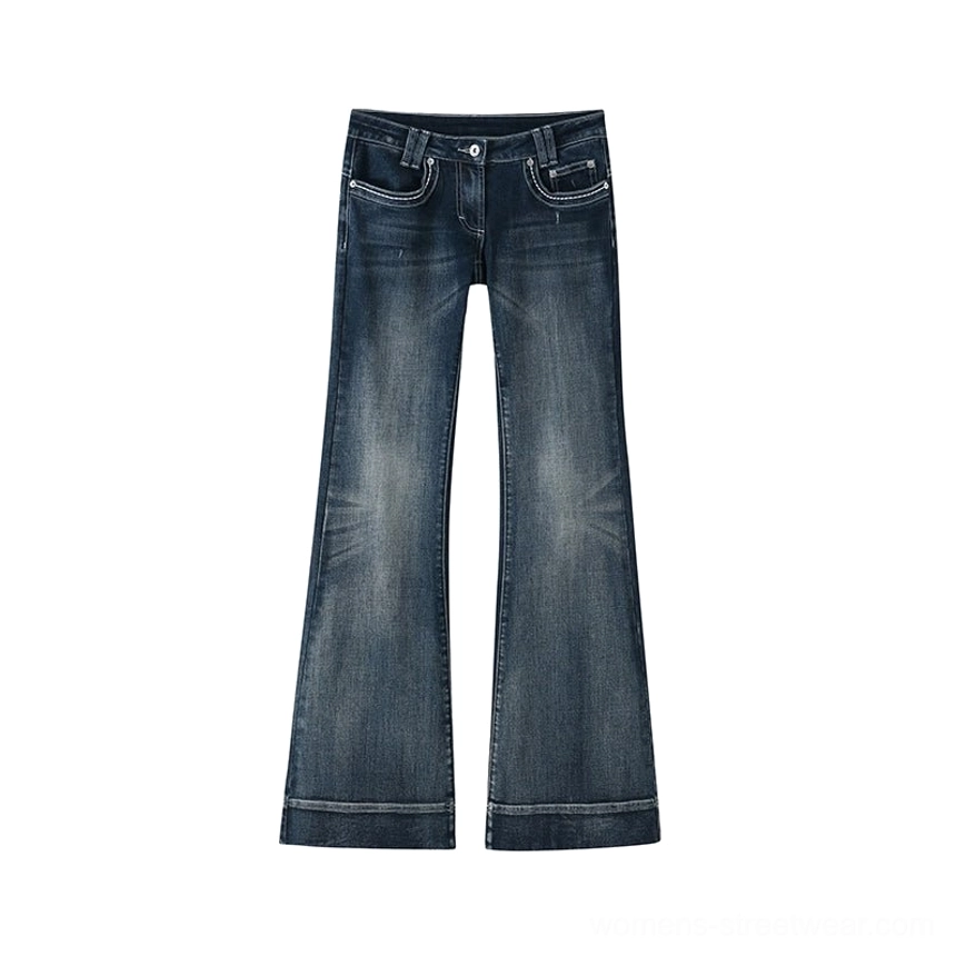 Back flat lay of dark indigo vintage flare jeans showing decorative back pockets, worn-in fading, flared legs, and contrasting hem stitching