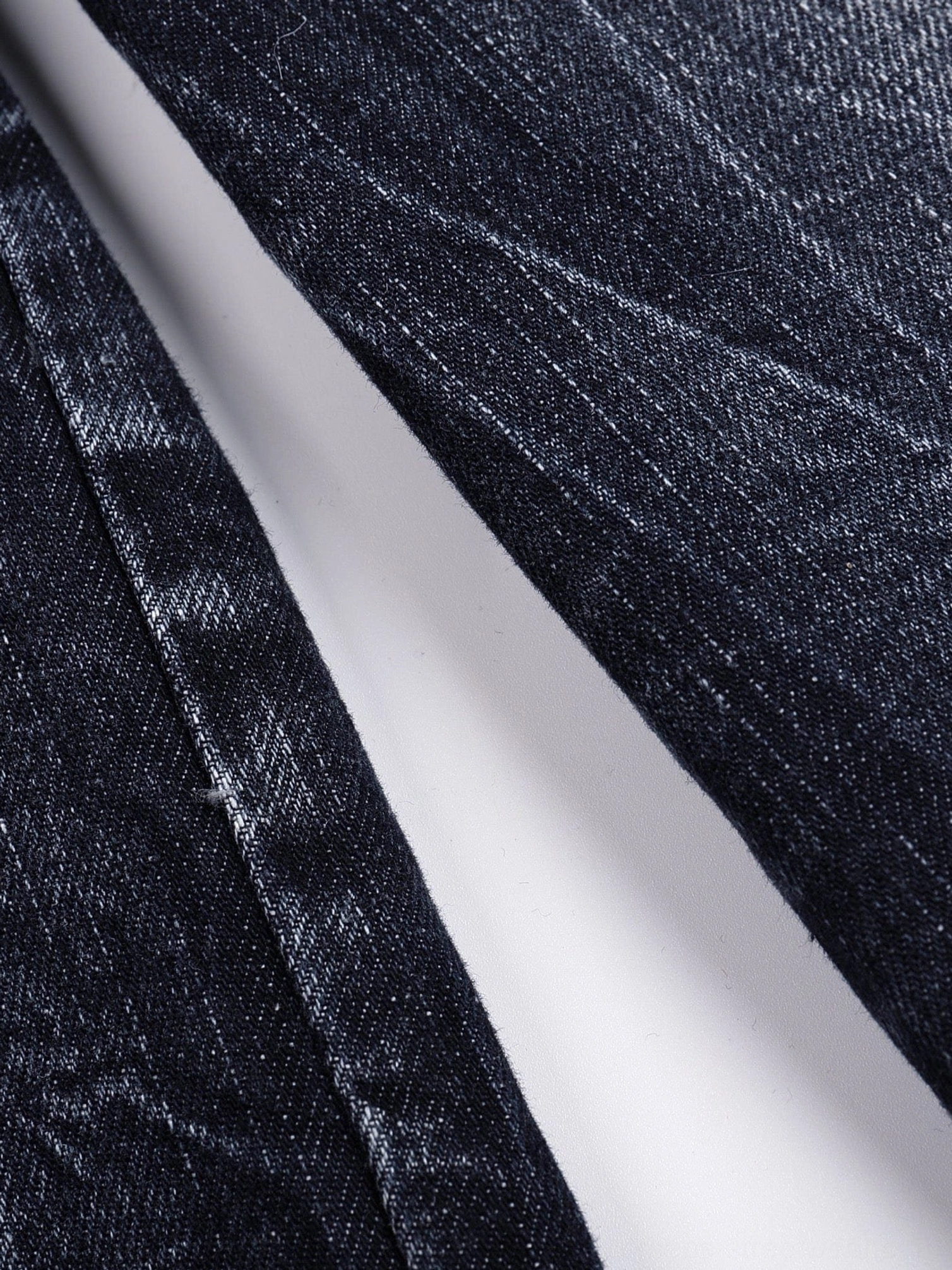 Dark indigo wide-leg streetwear jeans with bleached lightning details and a relaxed baggy silhouette