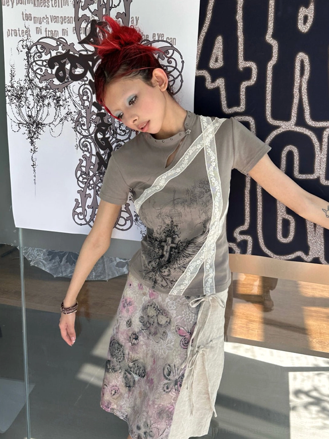 Dark khaki cross wing cheongsam collar slim fit tee styled with a floral wrap skirt in side studio view