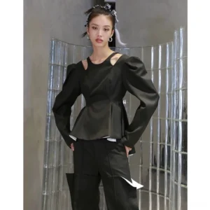 Front full-body view of dark military green cutout puff sleeve peplum top styled with matching wide-leg trousers in a modern streetwear studio