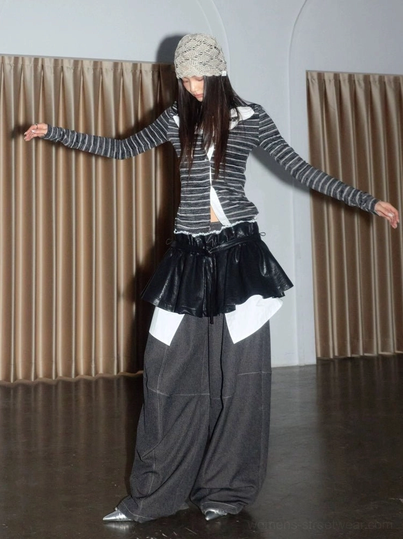 Front view of dark navy horizontal striped twist knit top styled with black ruffled mini skirt, gray wide-leg trousers, and pointed flats for layered Korean street fashion