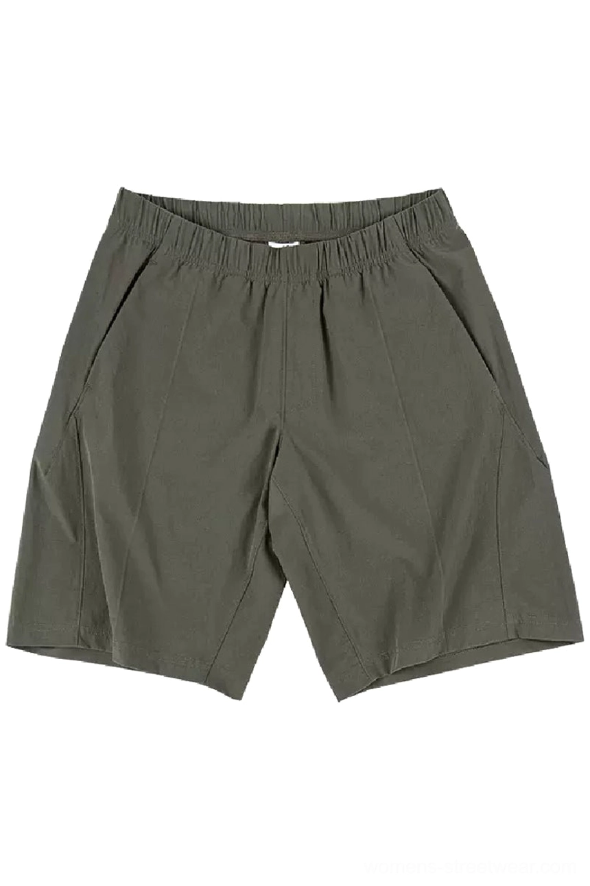 Front flat lay of dark olive green quick-dry tech shorts with elastic waistband, angled pockets, and tailored center seam