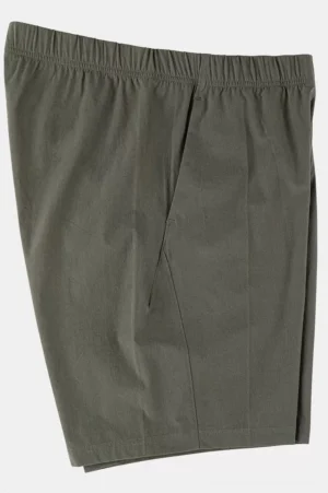 Three-quarter view of dark olive lightweight cotton tech shorts showing the elastic waistband, clean seams, and relaxed streetwear silhouette