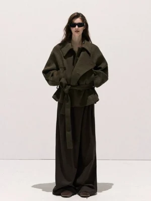Dark olive oversized wrap collar wool blend coat styled with dark brown wide-leg trousers and cinched waist tie in a full front view