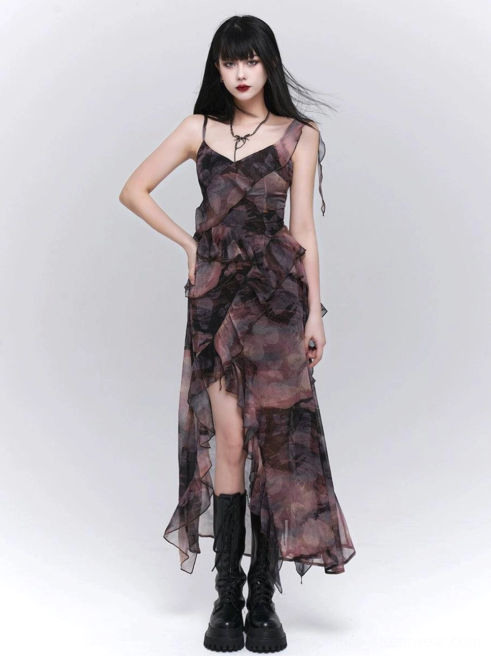Dark romantic sheer floral maxi dress styled with platform combat boots, adjustable spaghetti straps, slim waist, and asymmetrical ruffle hem