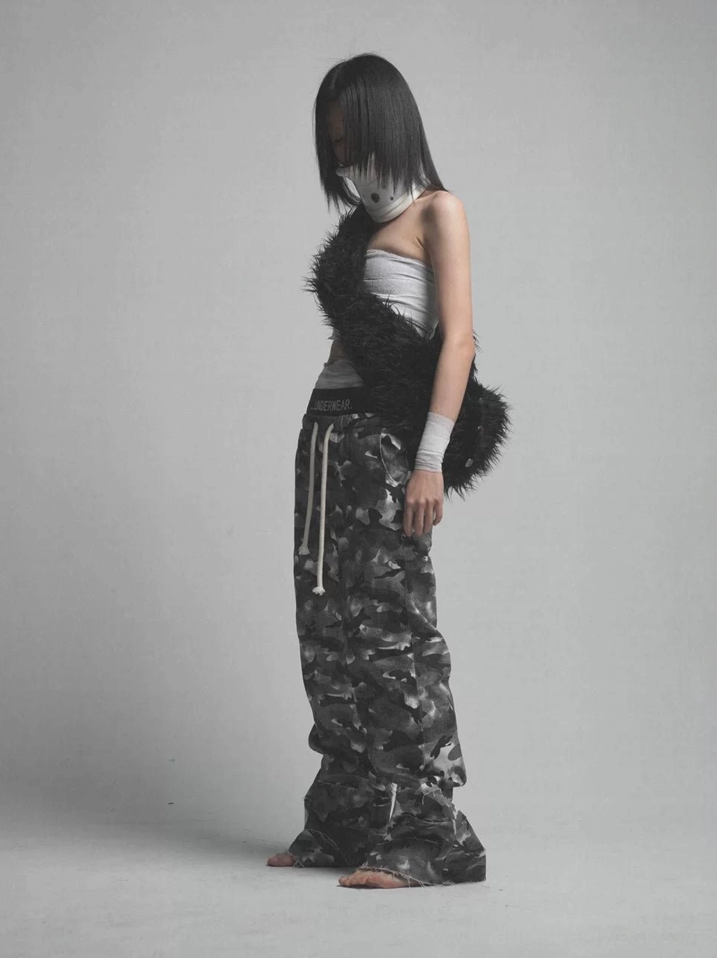Side studio view of dark smoke camouflage double waistband pants with baggy wide legs and adjustable drawstring waist