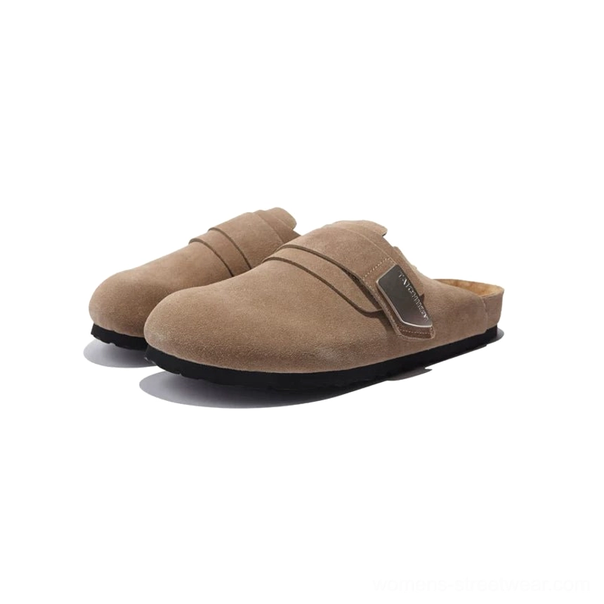 Dark tan closed-toe suede mule sandals with matching adjustable buckle strap and classic clog silhouette