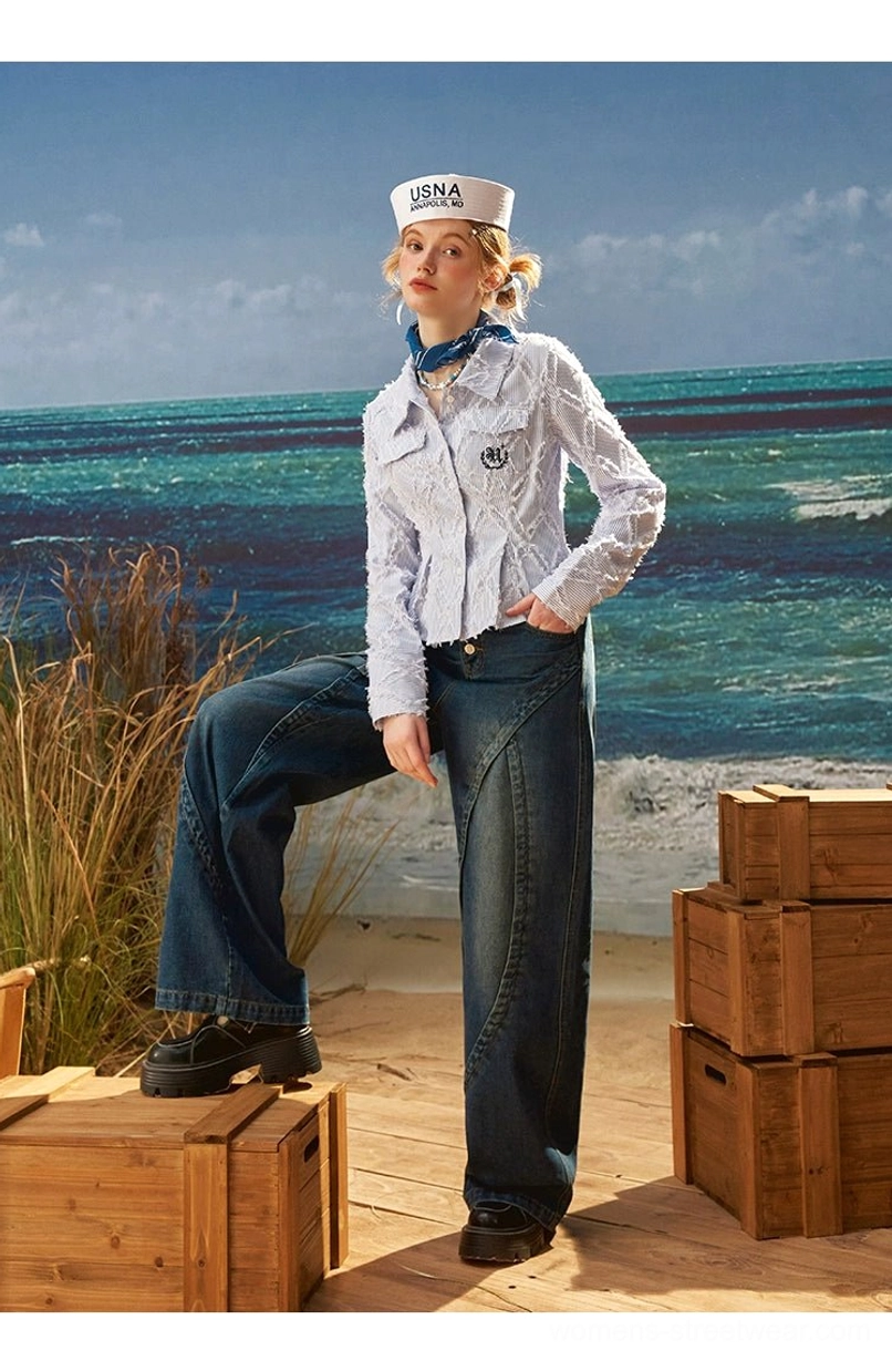 Side pose of dark vintage wash high rise wide leg jeans highlighting curved leg seams and relaxed full length silhouette