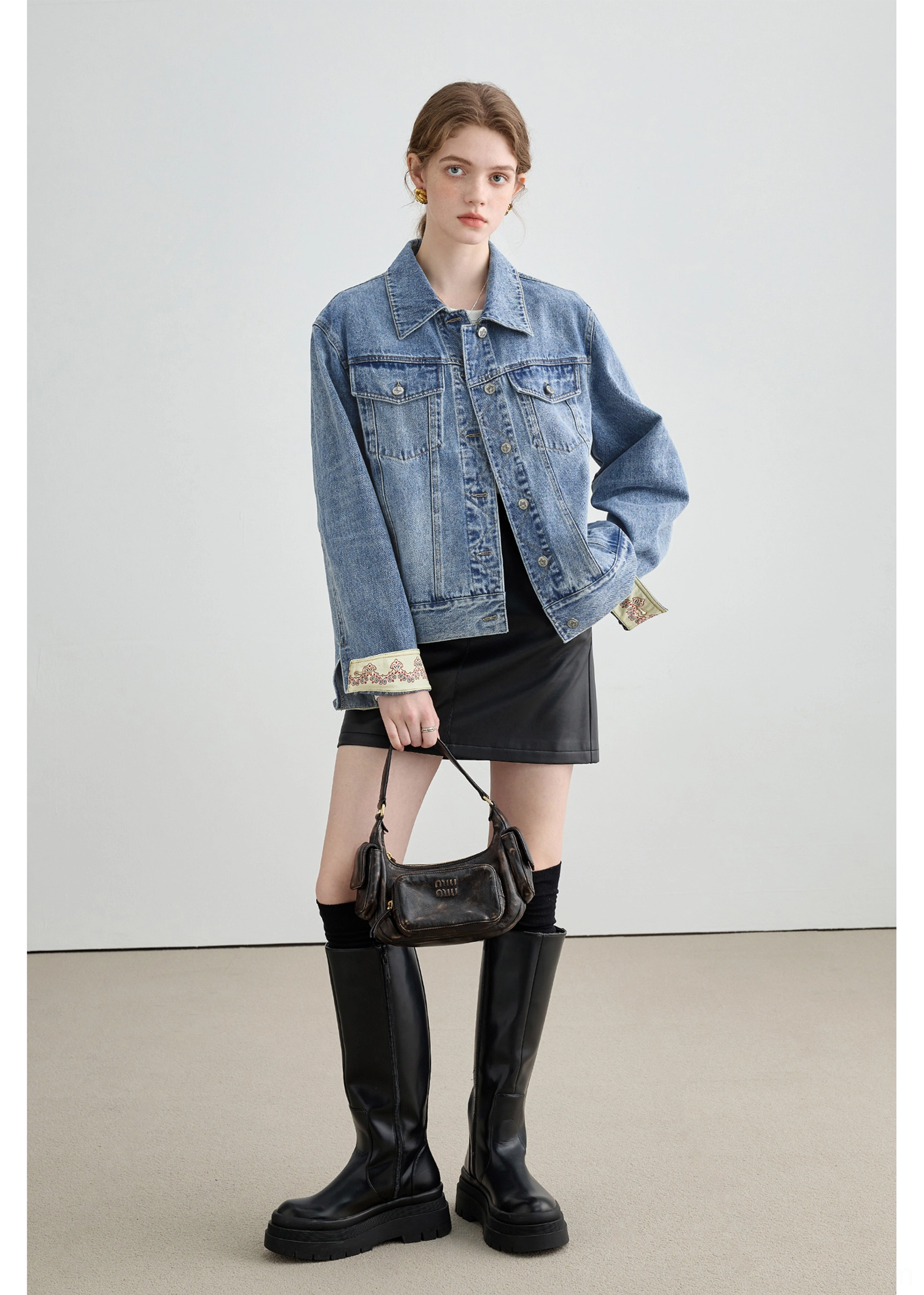 Dark wash denim jacket with brown corduroy collar and cuff details styled as contemporary womens streetwear