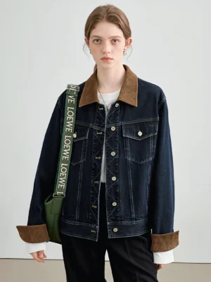 Female model wearing a dark wash denim jacket with brown corduroy collar, turned-back cuffs, contrast stitching, and relaxed streetwear fit
