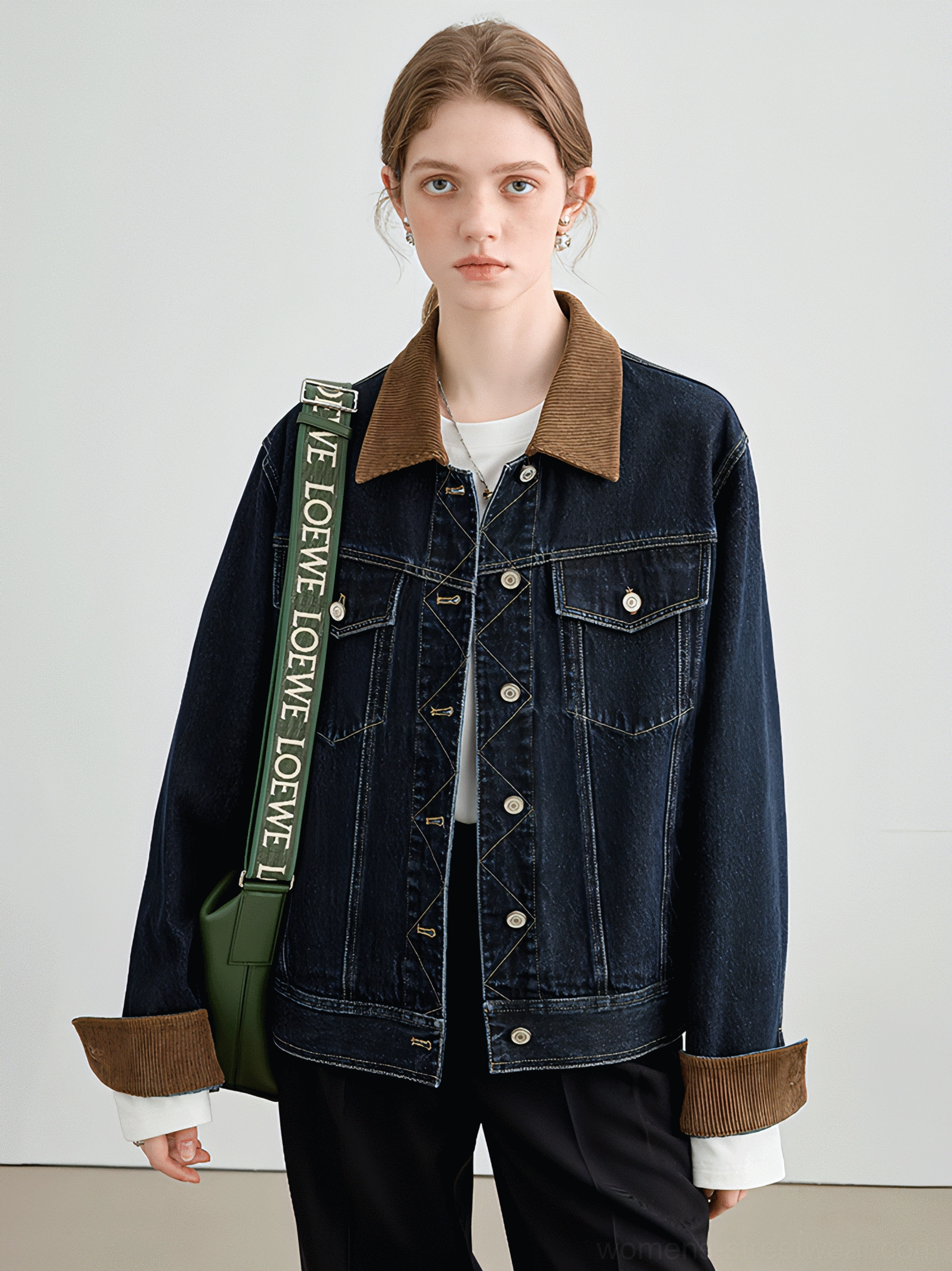 Female model wearing a dark wash denim jacket with brown corduroy collar, turned-back cuffs, contrast stitching, and relaxed streetwear fit