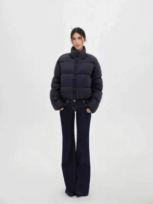 Full-body streetwear outfit featuring dark wash flared denim jeans styled with a puffer jacket for a modern Korean fashion look