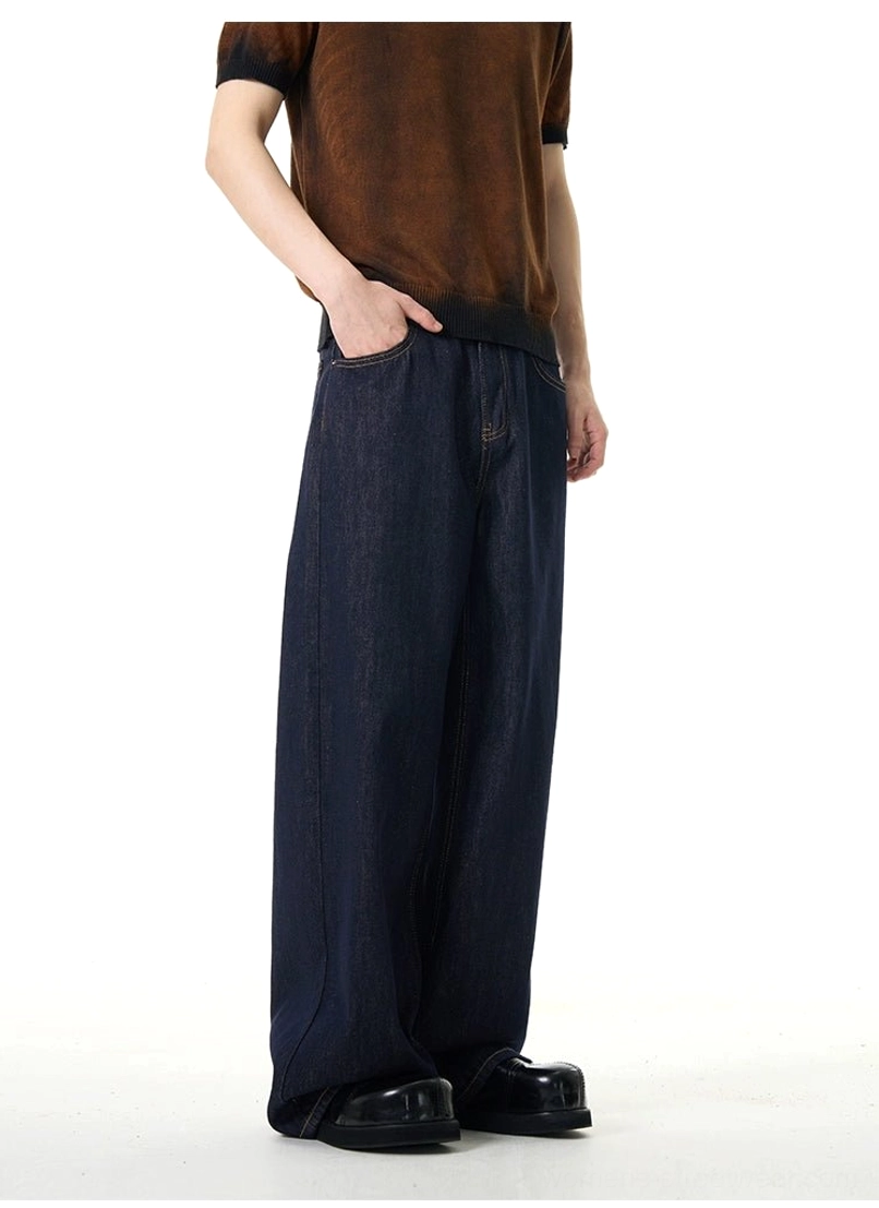 Side view of relaxed dark wash wide-leg jeans showing the smooth denim texture, roomy leg shape, waistband, and practical side profile
