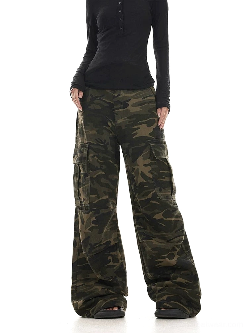 Three quarter front view of dark washed camo utility cargo pants with oversized wide leg silhouette
