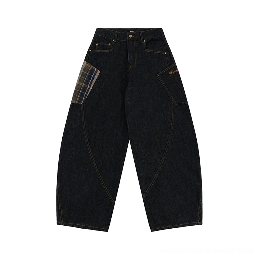 Flat lay of dark washed wide-leg denim cargo pants with brown plaid front patch pocket and curved seam details