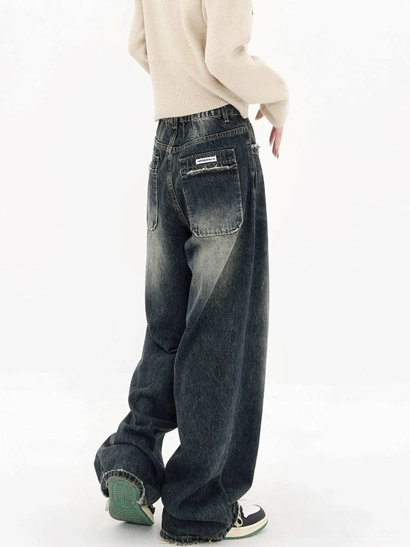 Deep blue high-waisted wide-leg jeans rear three-quarter view with faded vintage denim wash and relaxed streetwear fit