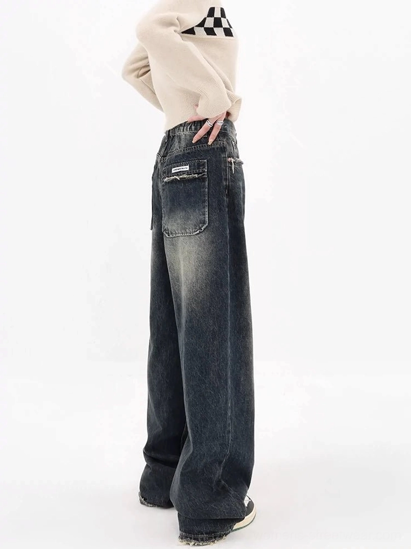Deep blue vintage wide-leg jeans side rear view showing loose leg shape front pocket and faded denim finish
