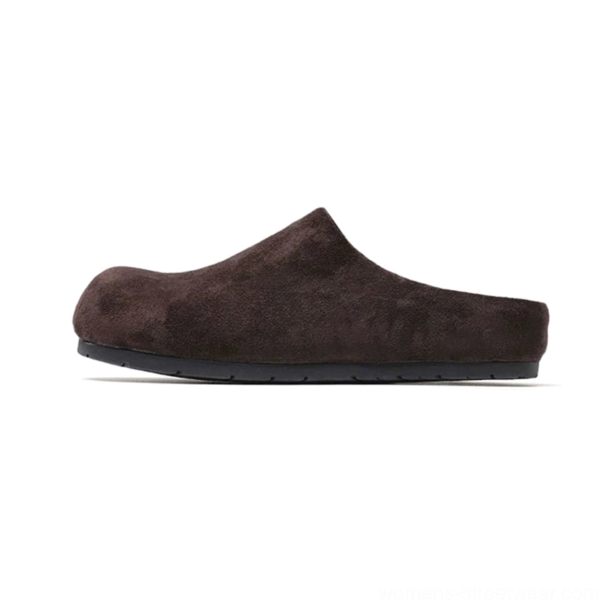 Deep brown suede-effect closed-toe mule clog shown in left side profile with rounded toe, backless slip-on shape, and flat outsole