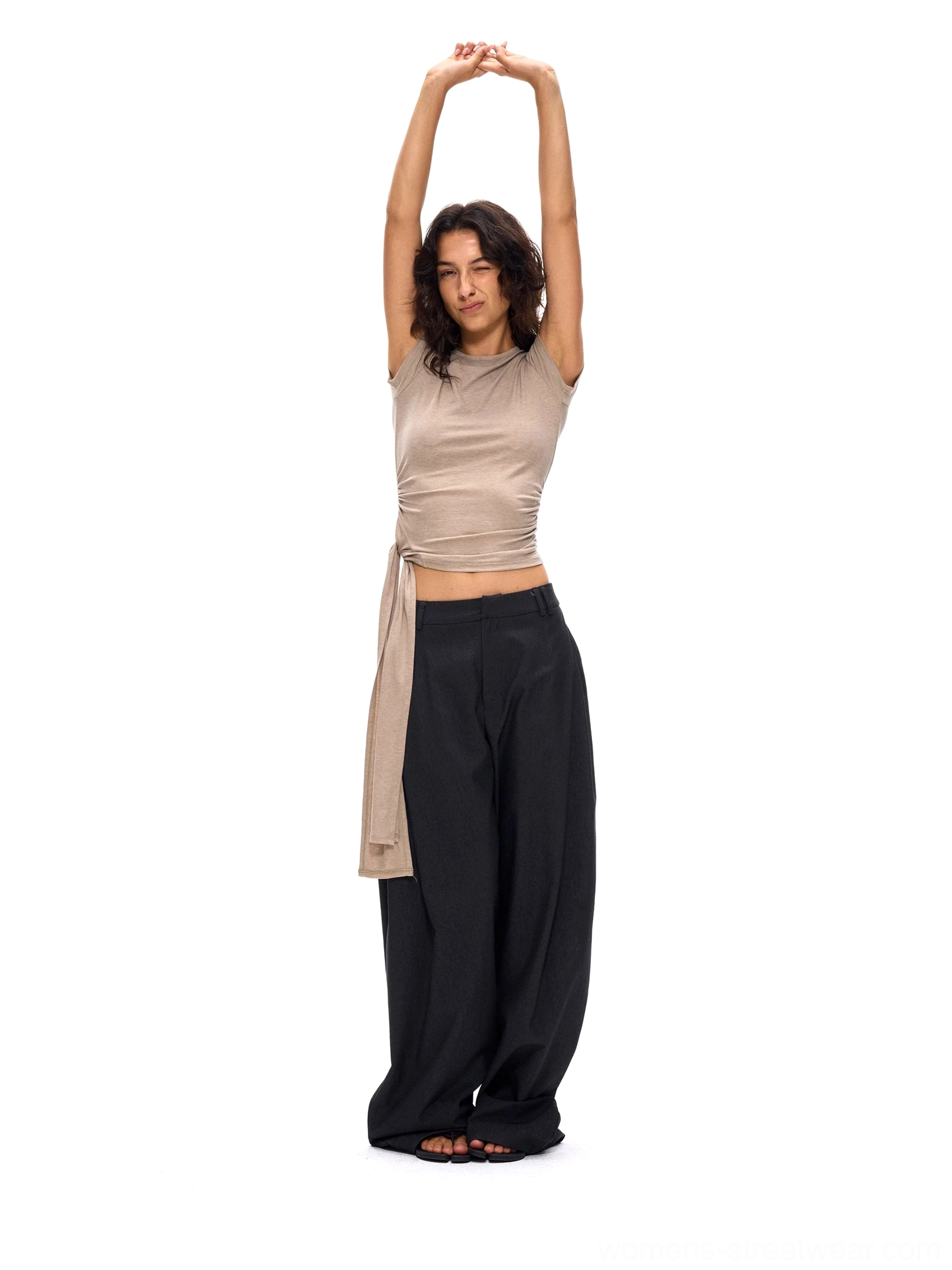 Deep gray relaxed wide-leg suit pants shown in a low-angle full-body view with a fluid drape and modern Korean streetwear silhouette