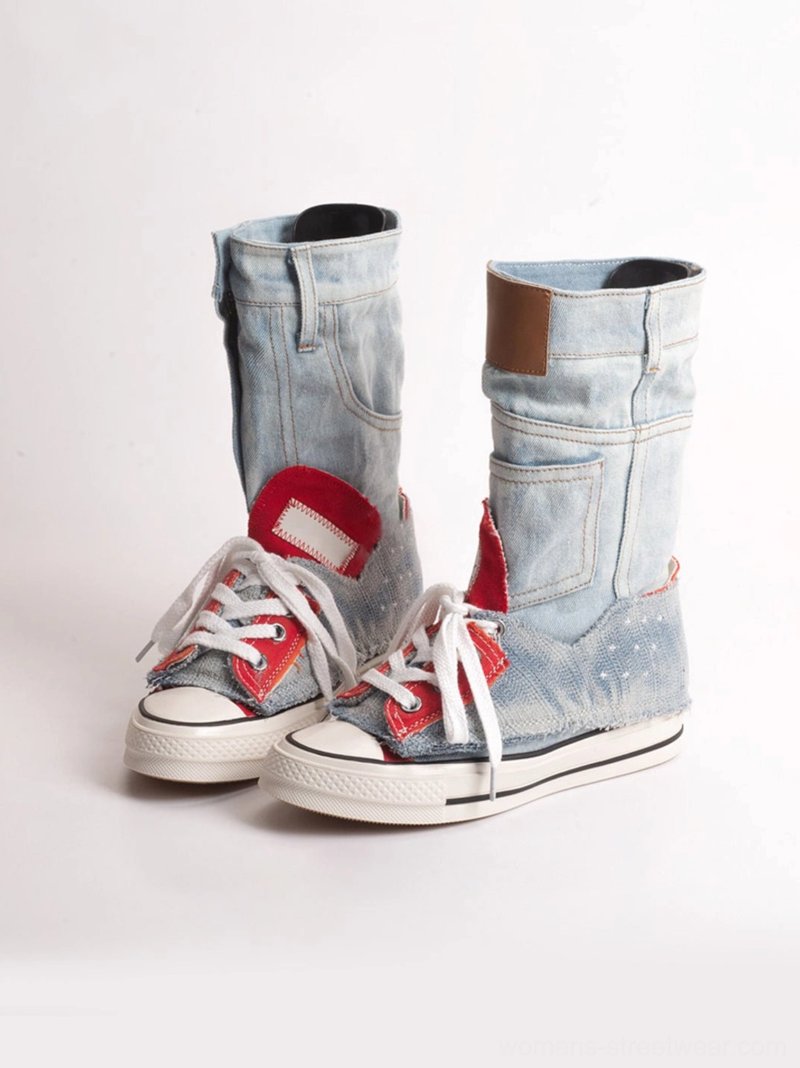 Three-quarter product view of light wash blue denim fold-cuff high-top platform sneakers with visible cuff pocket detail and white soles
