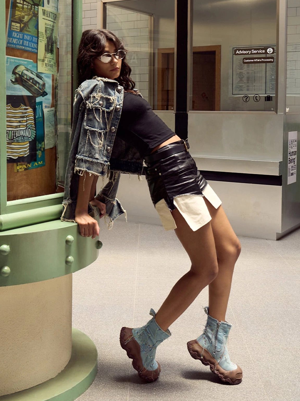 Model wearing denim fringe western ankle boots with a Y2K denim streetwear outfit in a subway setting