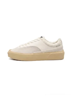 Desert gray platform canvas sneakers shown from the side with a pale textile upper, layered suede-style panels, tonal laces, rounded toe, and thick creamy vintage-tone rubber outsole