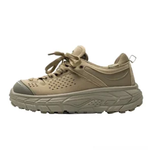 Desert yellow chunky trail sneakers shown in a left side studio profile with perforated breathable upper, layered panels, heel pull tab and deep lug rubber outsole