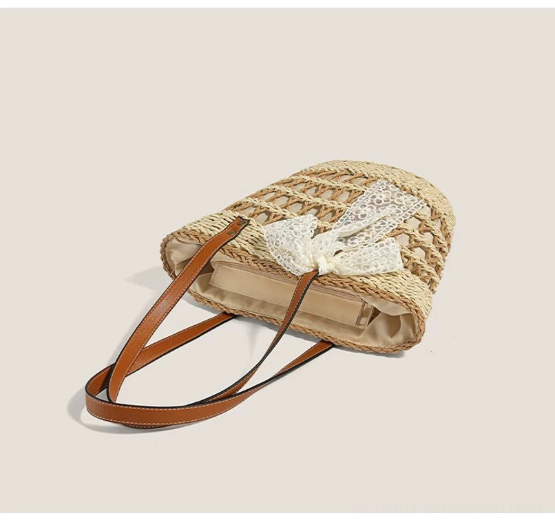 Top side view of a woven straw basket tote showing the detachable white lace bow, beige lining, and textured exterior