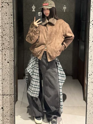 Layered plaid balloon leg denim pants styled with a cropped shearling collar jacket in an indoor mirror outfit view