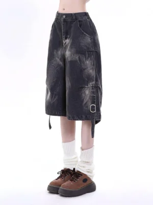 Distressed black denim cargo Bermuda shorts styled with white leg warmers and brown platform shoes, featuring wide legs, bleached fading, cargo pockets, and buckle straps