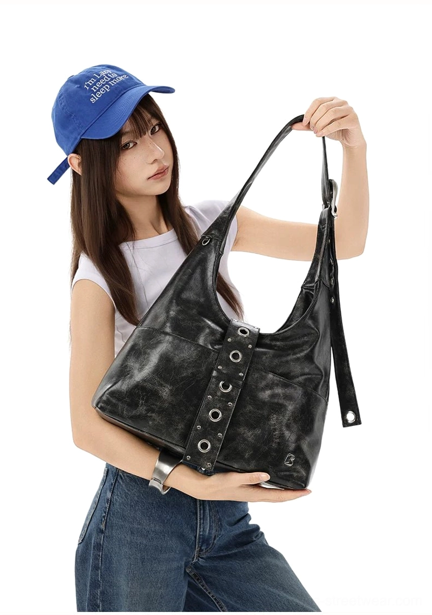 Distressed black rivet harness hobo bag front three-quarter view with silver hardware