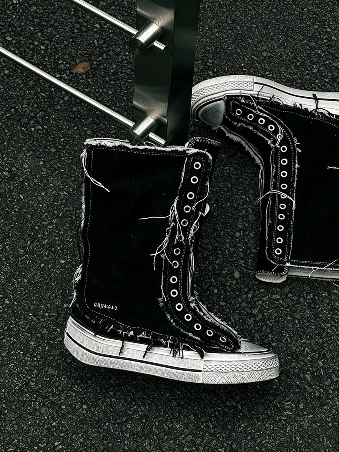 Distressed canvas platform boots for women with lace-up high-top design, frayed details, rubber toe cap, and elevated sole