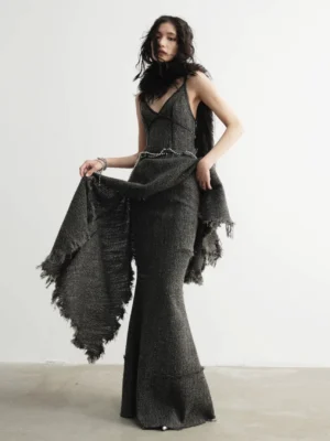 Distressed charcoal tweed mermaid maxi skirt styled in a dark romantic streetwear outfit, front three-quarter view