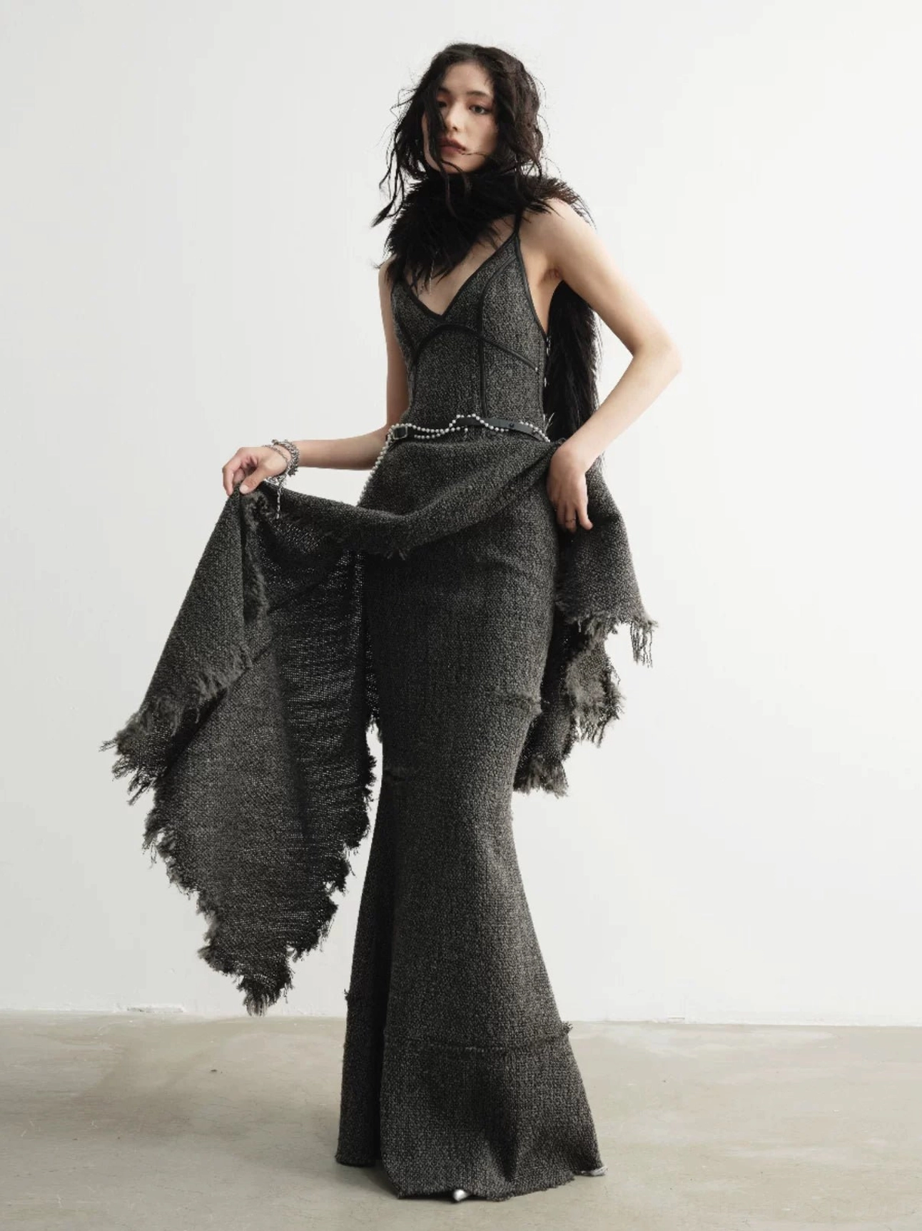Distressed charcoal tweed mermaid maxi skirt styled in a dark romantic streetwear outfit, front three-quarter view