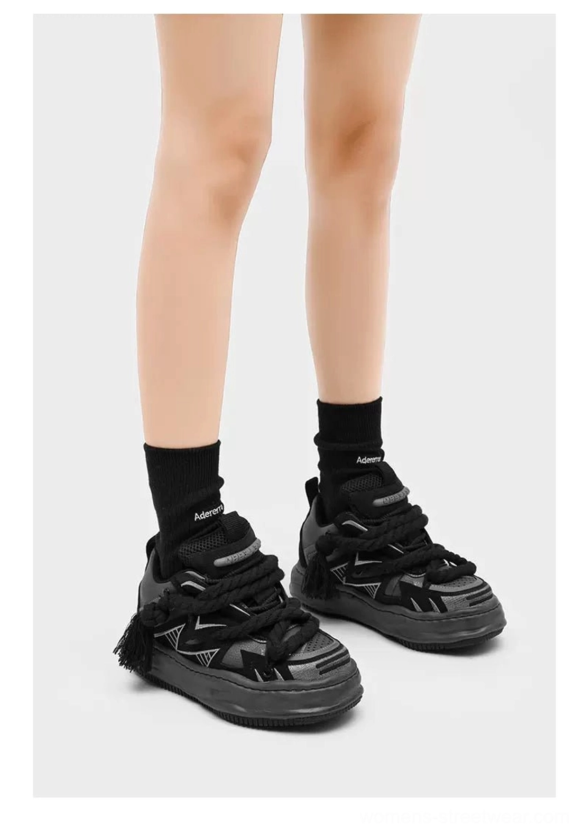 Distressed chunky sneakers featuring decorative braided rope laces, textured rubber traction sole, mesh lining, and a bold avant-garde streetwear silhouette
