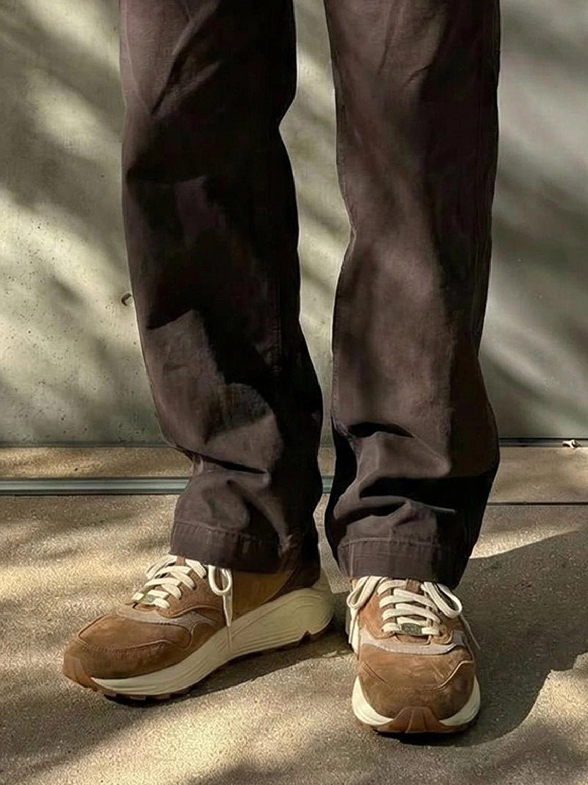 Distressed coffee brown retro sneakers with suede overlays chunky sole and outdoor inspired styling